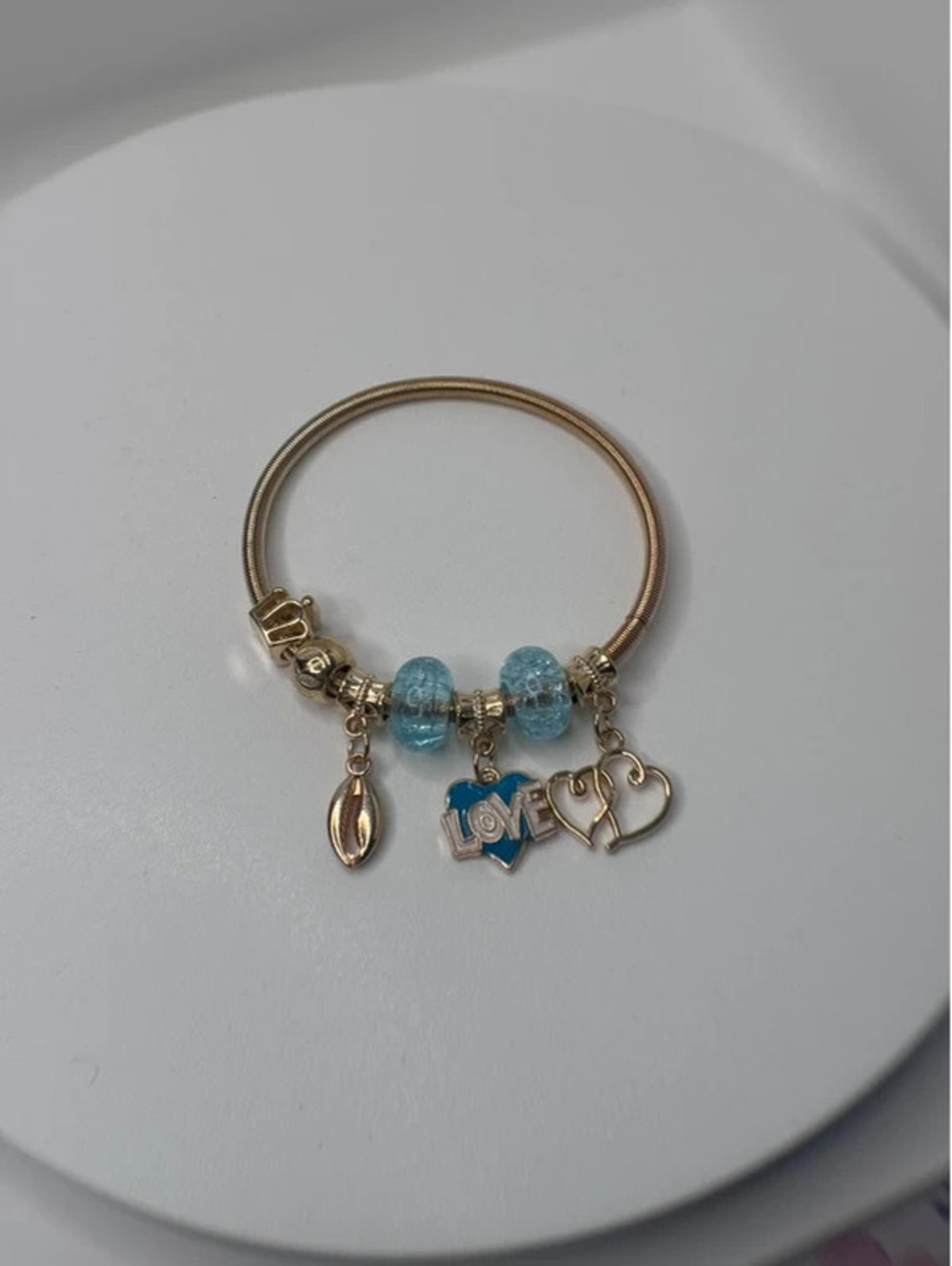 Blue and gold tone charm fashion bracelet